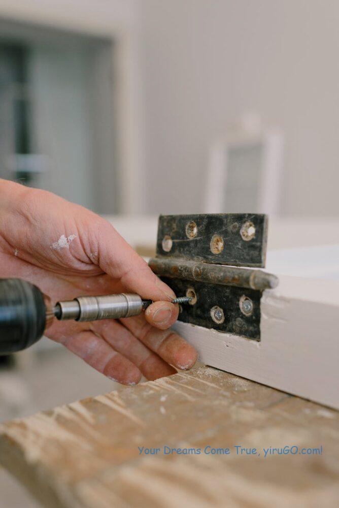 crop man installing metal hinge